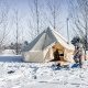 bell tent in snow with stove