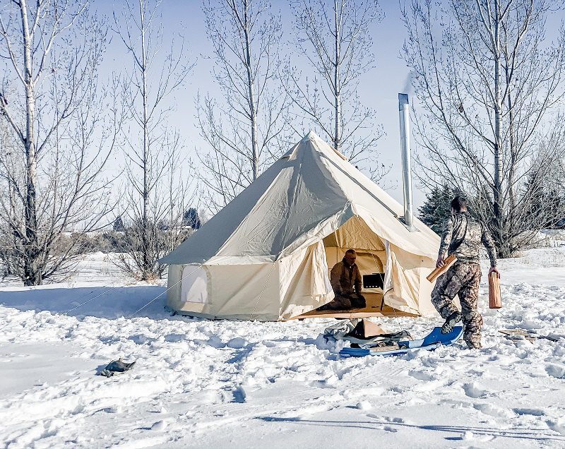 bell tent in snow with stove
